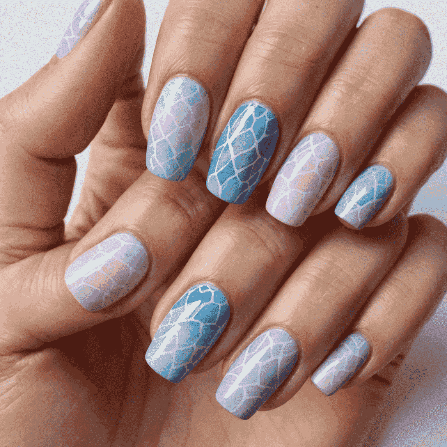 Nails featuring soft, blended watercolor-like patterns in pastel pinks, purples, and blues