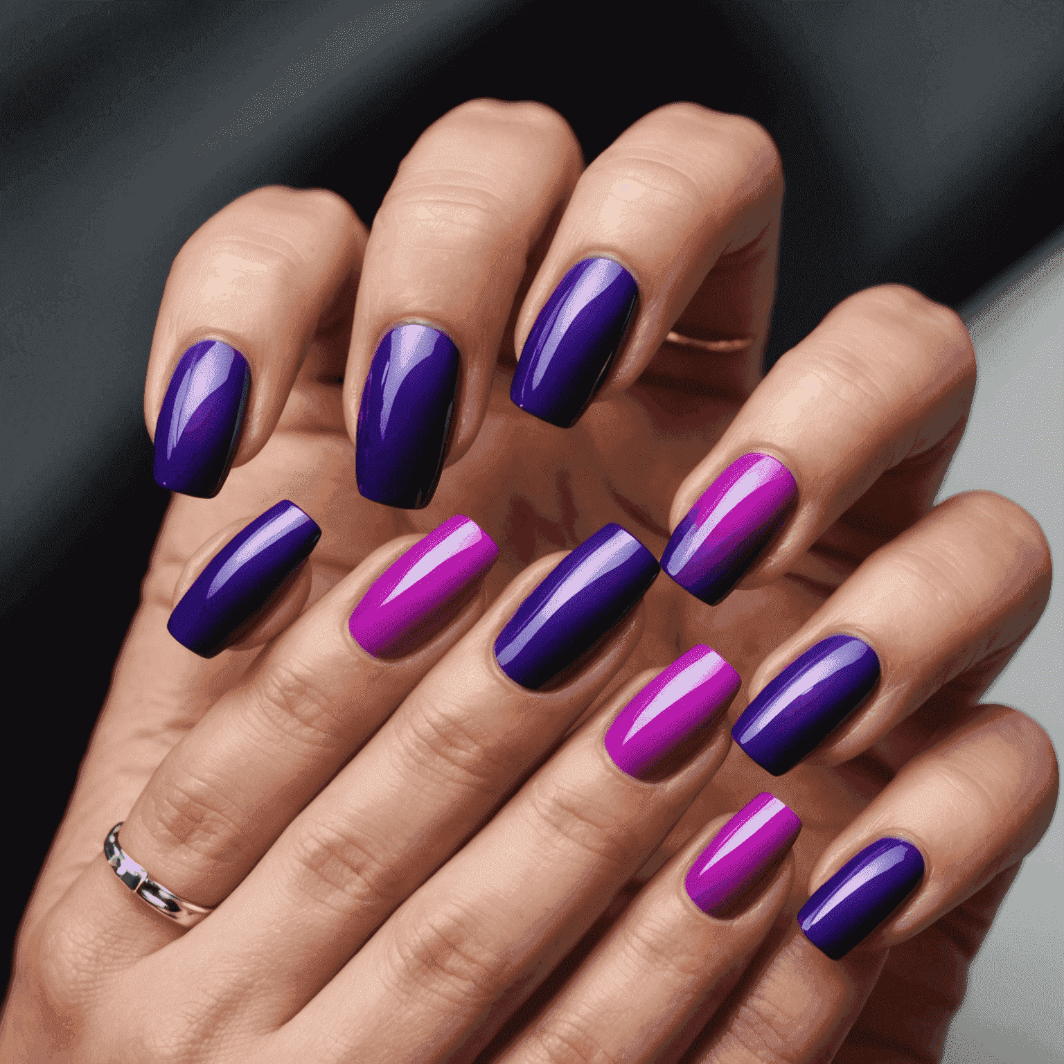 A set of nails displaying a smooth gradient from hot pink to deep purple with an ultra-glossy finish